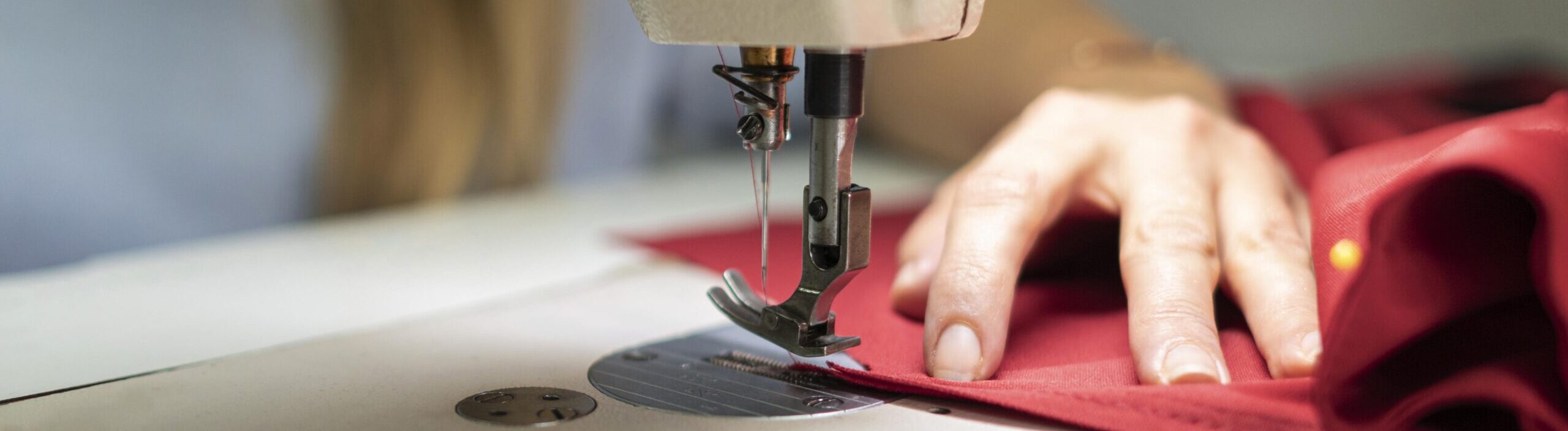close-up-hands-sewing-with-machine